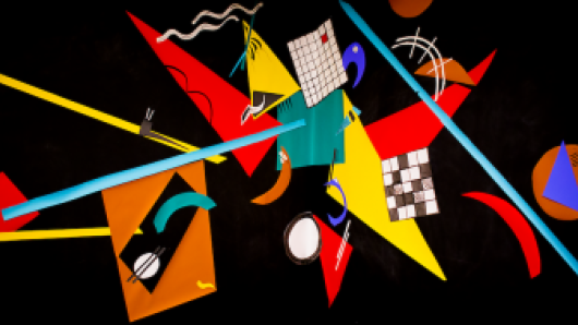Black background with red, yellow, blue, and white geometric shapes arranged asymmetrically.