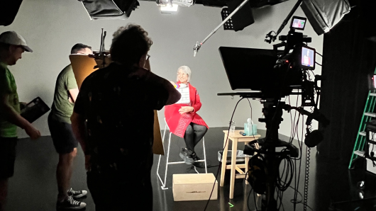 Photo of Professor Banaji filming for her course Outsmarting Implicit Bias in a film studio.
