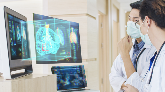 harvard university strategic plan 2020 Two masked health care workers looking at AI images on a computer screen
