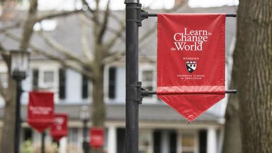 Red Banner in court yard that reads Learn to Change the World
