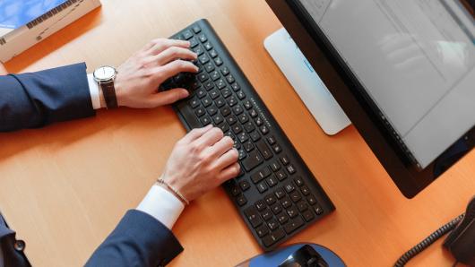 Hands on a keyboard in office