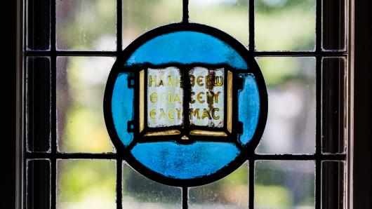 Stained glass window with religious text